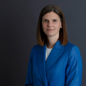 Kate Symons standing in front of a navy background
