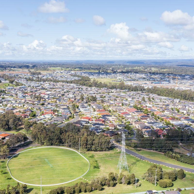 aerial view of an Australian suburb with a sports field in the foreground