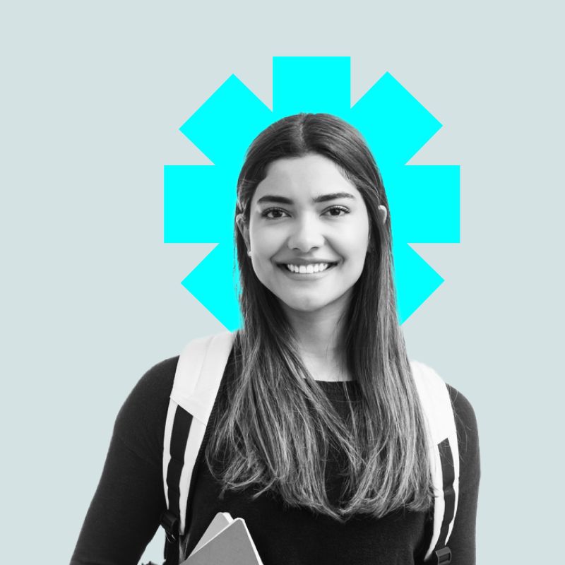 A woman with a backpack smiles at the camera against a light blue background. 