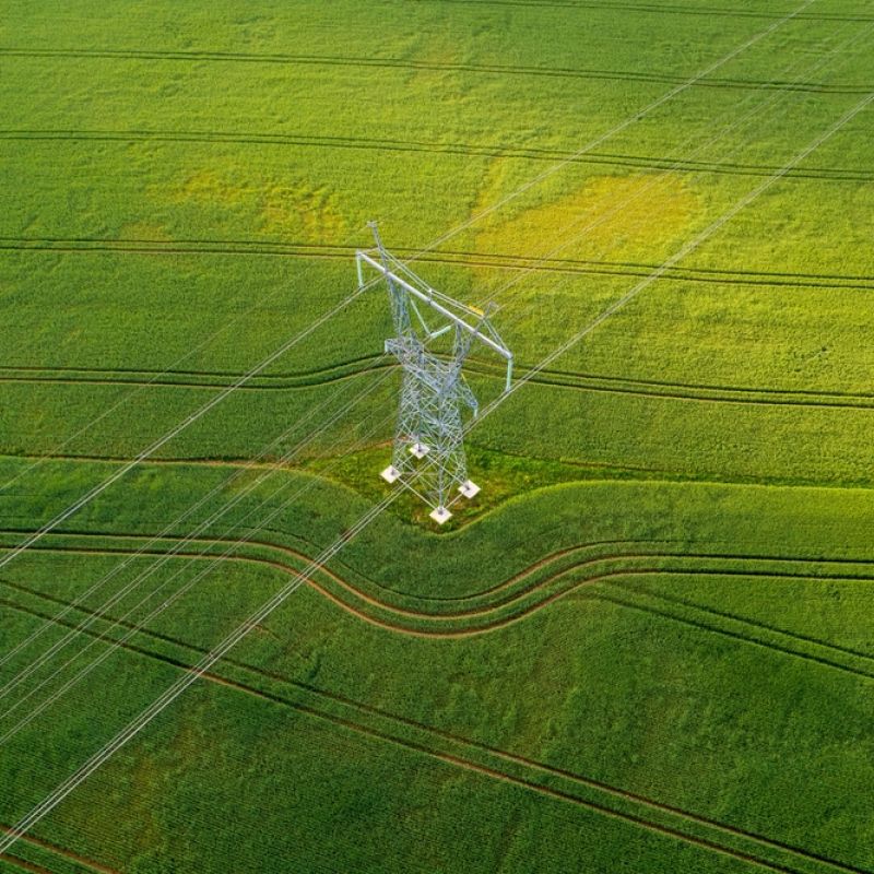 A transmission tower in a green field