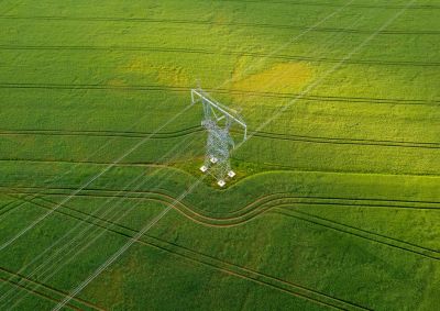 A transmission tower in a green field