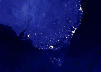 A satellite image of Australia's east coast, showing the lights of the major cities