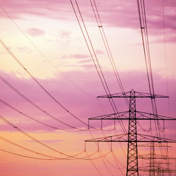 Transmissions lines backed by the colours of a clouds during a sunset